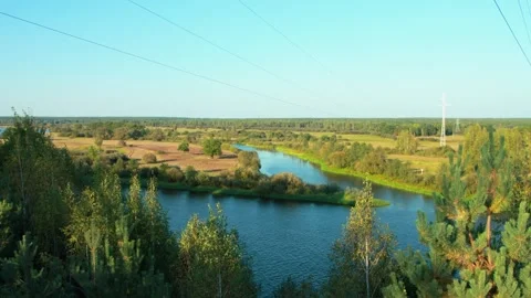 A beautiful view from the cliff to the river and field in summer against the 스톡 동영상 265594472