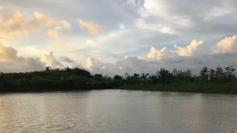 Beautiful View of clouds in the afternoon sky over a rural lake Stock Footage 223361489