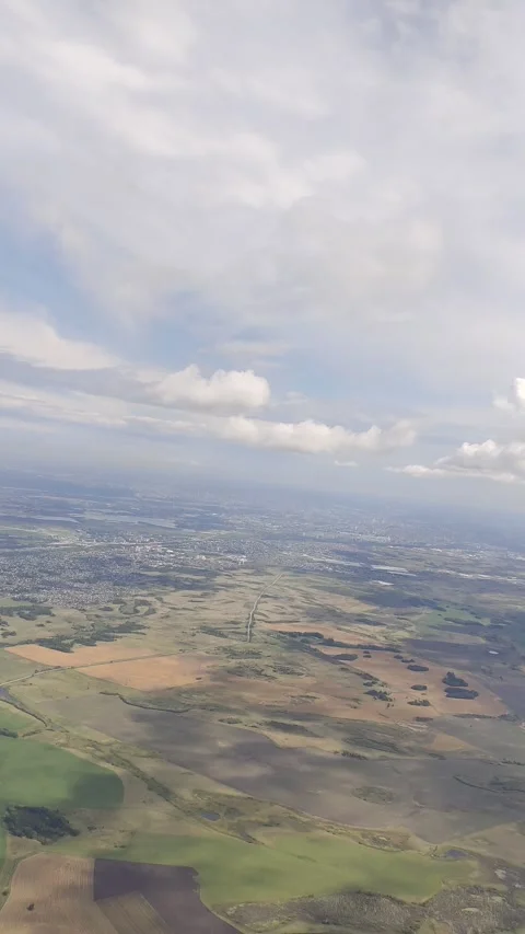 Beautiful view of clouds and earth from the airplane window. Stock Footage 320284413