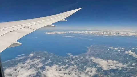 Beautiful view of the clouds in the sky from the window of a plane Stock Footage 209148079