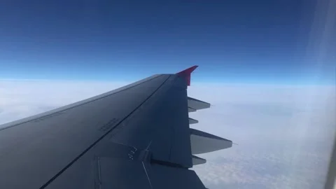 Beautiful view of the clouds through the porthole. View from the window of the Video stock 202114384