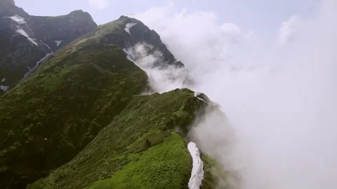 The beautiful view of the cloudy mountain peaks Stock Footage 242326150