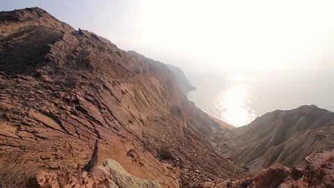 Beautiful view of the colored desert rocky mountains with Persian Gulf. Hormuz Stock Footage 104857612