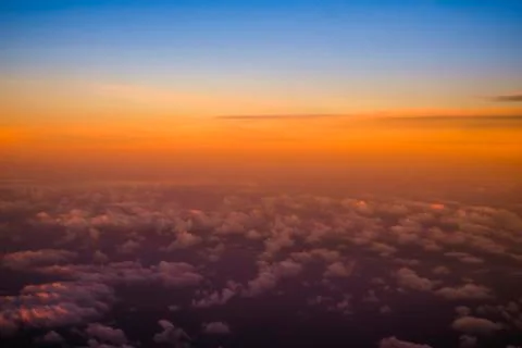 Beautiful view  of cumulus clouds with sunset at atmosfera from airplain wind Stock Photos