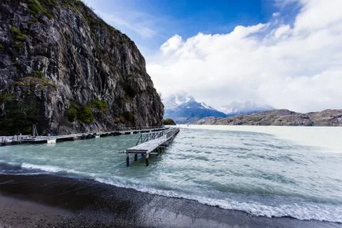 Beautiful view of deck during low tide in Glacier Gray, with mountain range w Stock Photos