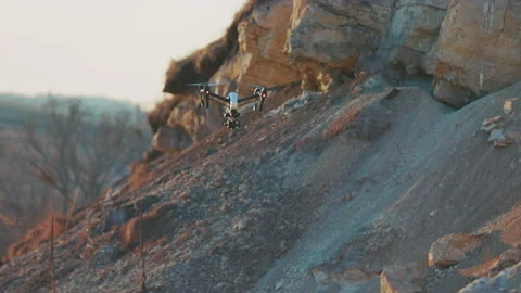 Beautiful view of drone flies on background rock. Modern technologies for Stock Footage 175401715