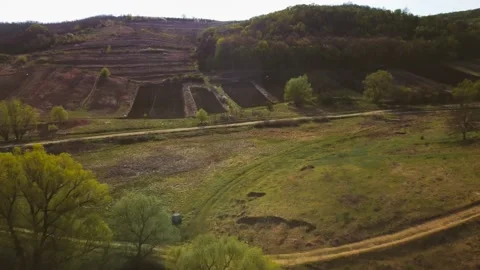 A beautiful view from a drone on a hill with a forest. Fields with crops Stock Footage 184383831
