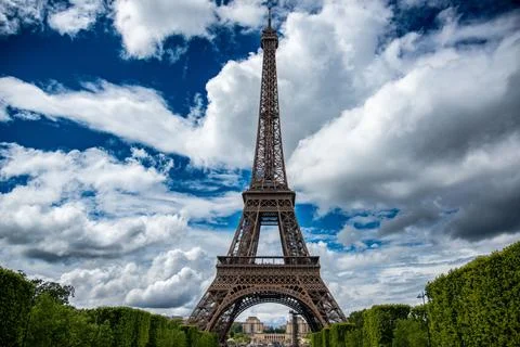 Beautiful view of the Eiffel Tower against a blue cloudy sky in Paris, France Stock Photos