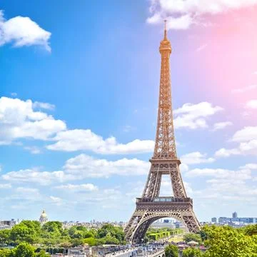 Beautiful view on Eiffel Tower, Paris, France. Sunny summer day. White clouds Stock Photos
