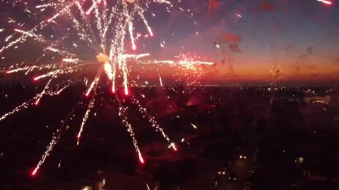 Beautiful view of exploding fireworks over a neighborhood in the evening Stock Footage 236797099