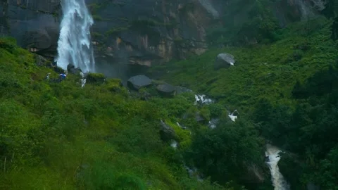 Beautiful view of flowing Jogini waterfall and water streams in mountain covered Stock Footage 239362824
