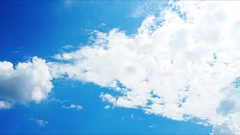 A beautiful view of fluffy white clouds drifting across a bright blue summer sky 库存影片 334795875