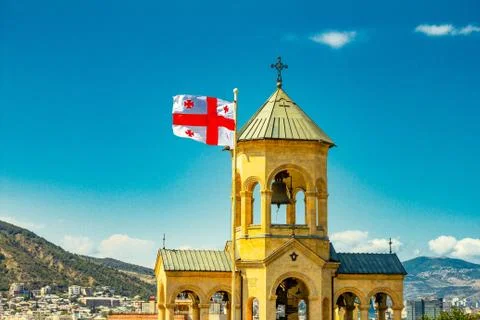Beautiful view to Georgian Flag on the background chapel on site to Sameba Ca Stock Photos