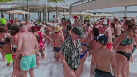 A group of young giels dancing at a foam party, beach party, Nissi