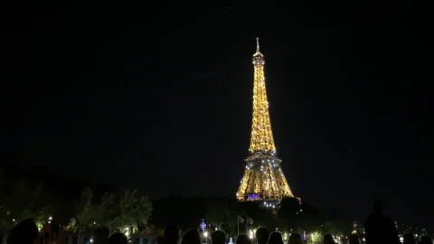 Beautiful view of the glowing Eiffel Tower during nighttime Video stock 241237030