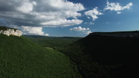 Beautiful view of the green valley from above. The drone flies over a valley Stock Footage 256306372