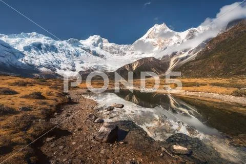 Beautiful view with high rocks with snow covered peaks, stones i Stock Photos