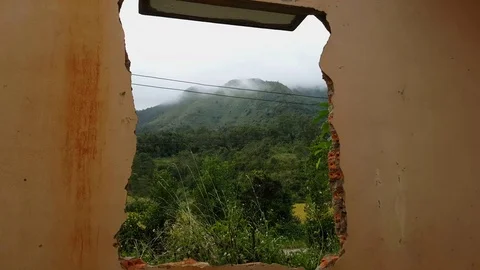 Beautiful view of hills and fields through broken window in abandoned house Vídeos de archivo 80706146