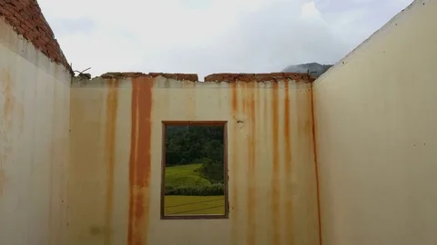 Beautiful view of hills and fields through window in abandoned roofless house 스톡 동영상 80721468