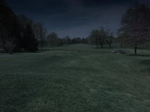 Beautiful view looking down the fairway of a public golf course at night befo Stock Photos