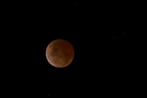 Beautiful view of a Lunar Eclipse full totality on a black background Stock Photos