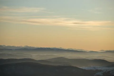 Beautiful view of the mountain range partially covered with snow just before  Stock Photos