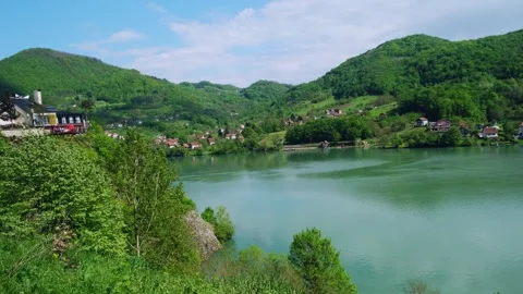 Beautiful view of mountain river and small village from the observation deck. Video stock 243618633