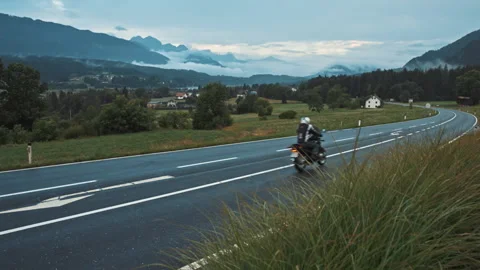Beautiful view of mountain road during summertime on highway. Motorbike driving Stock Footage 135193022