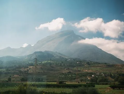 Beautiful view of mountains fields blue sky and clouds in Sicily Stock Photos