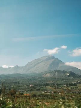 Beautiful view of mountains fields blue sky and clouds in Sicily Stock Photos