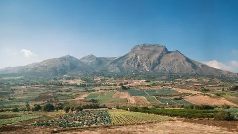 Beautiful view of mountains fields blue sky and clouds in Sicily Stock Photos