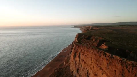 A beautiful view of the ocean with a cliff in the background Stock Footage 298248358