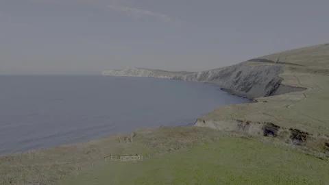 A beautiful view of the ocean with a cliff in the background Stock Footage 298280475