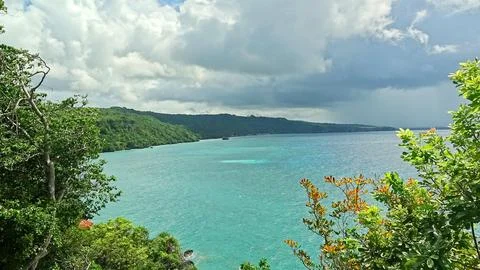 A beautiful view of the ocean with a cloudy sky in the background Stock Photos
