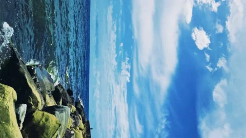 Beautiful View Ocean Rocks White Clouds Blue Sunny Sky Horizon Vertical Footage. Video stock 289068685