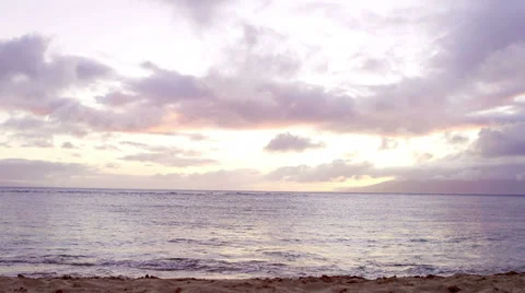 A beautiful view of the ocean as the sun sets behind it. Wide shot. Stock Footage 33895791