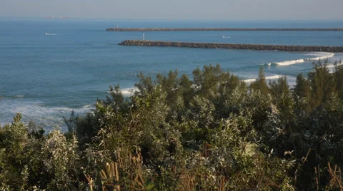 Beautiful view of ocean with two ski boats going out to sea Stock Footage 32255688