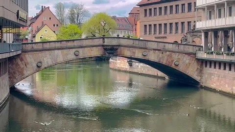 Beautiful view of Old bridge above calm water river with colorful buildings Stock Footage 317359744