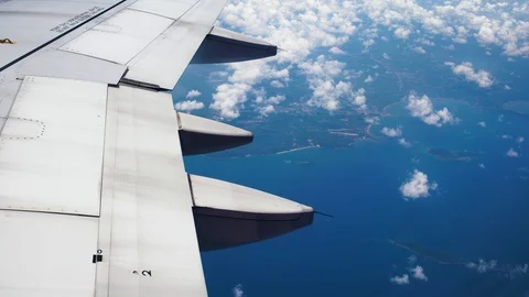 Beautiful view over the wing of a flying plane over tropical Islands Stock-Footage 88285575