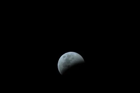 Beautiful view of a Partial Lunar Eclipse before totality on a black background 스톡 사진