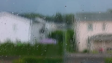 Beautiful view of raindrops rolling down window glass in house on rainy. Stock Footage 247019198