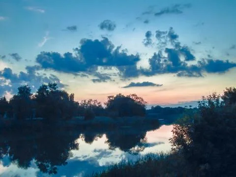 Beautiful view of the reflection of clouds in the water in the evening Stock Photos
