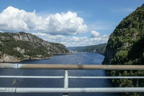 A beautiful view of a river with a bridge in the background in Norway Stock Photos