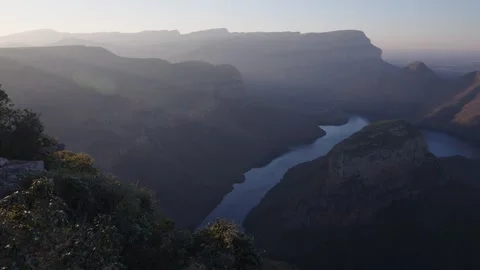 Beautiful view of River flowing through a mountainous range with a misty look Stock Footage 278802595