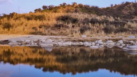 Beautiful view of an River with stone side, and yellow mountain Drone Ariel view Stock Footage 168504683