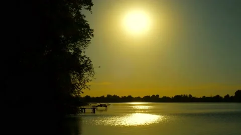 Beautiful view of the river at sunset. Black silhouettes of trees, boats, Stock Footage 135551852
