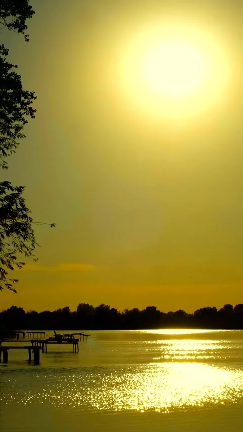 Beautiful view of the river at sunset. Black silhouettes of trees, boats, a.. Stock Footage 285707841