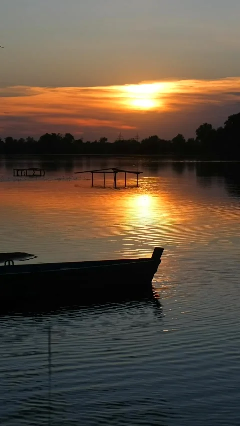 Beautiful view of the river at sunset. Black silhouettes of trees, boats, a.. Stock Footage 291950648