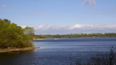 Beautiful view of the river through the trees, reflection of clouds on the water Stock Footage 109258604