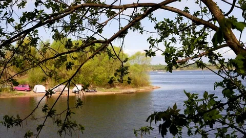 Beautiful view of the river through the trees, reflection of clouds on the water Stock Footage 109258659